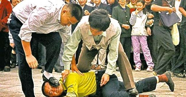 A Falun Gong practitioner overpowered and arrested in Tiananmen Square